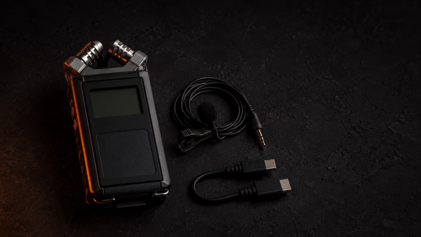 Compact portable audio recorder with a lavalier and a cable beside it