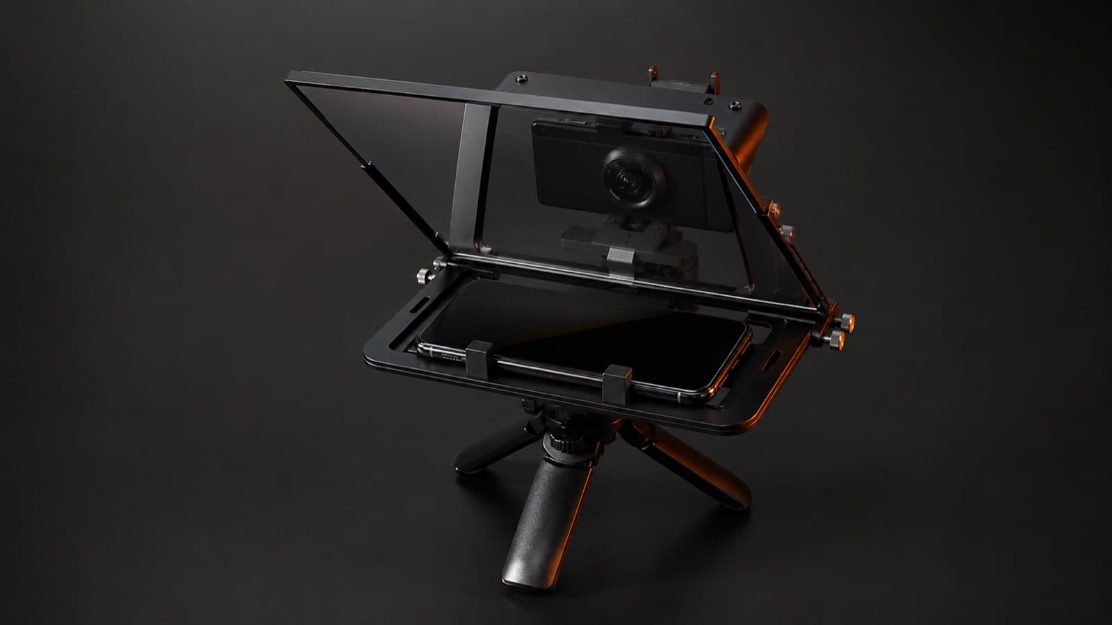 A phone teleprompter rig with beam-splitter glass at 45° mounted on a tabletop tripod